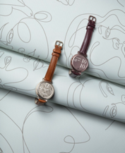 A couple of watches on a roll of paper

Description automatically generated