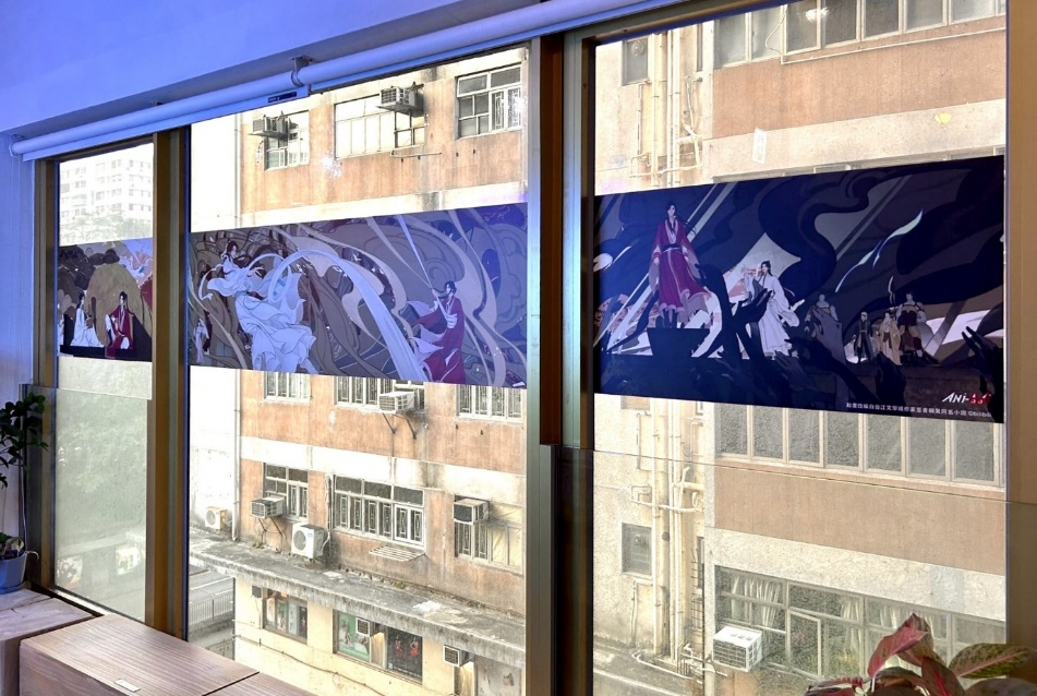 A window with a couple of posters
Description automatically generated